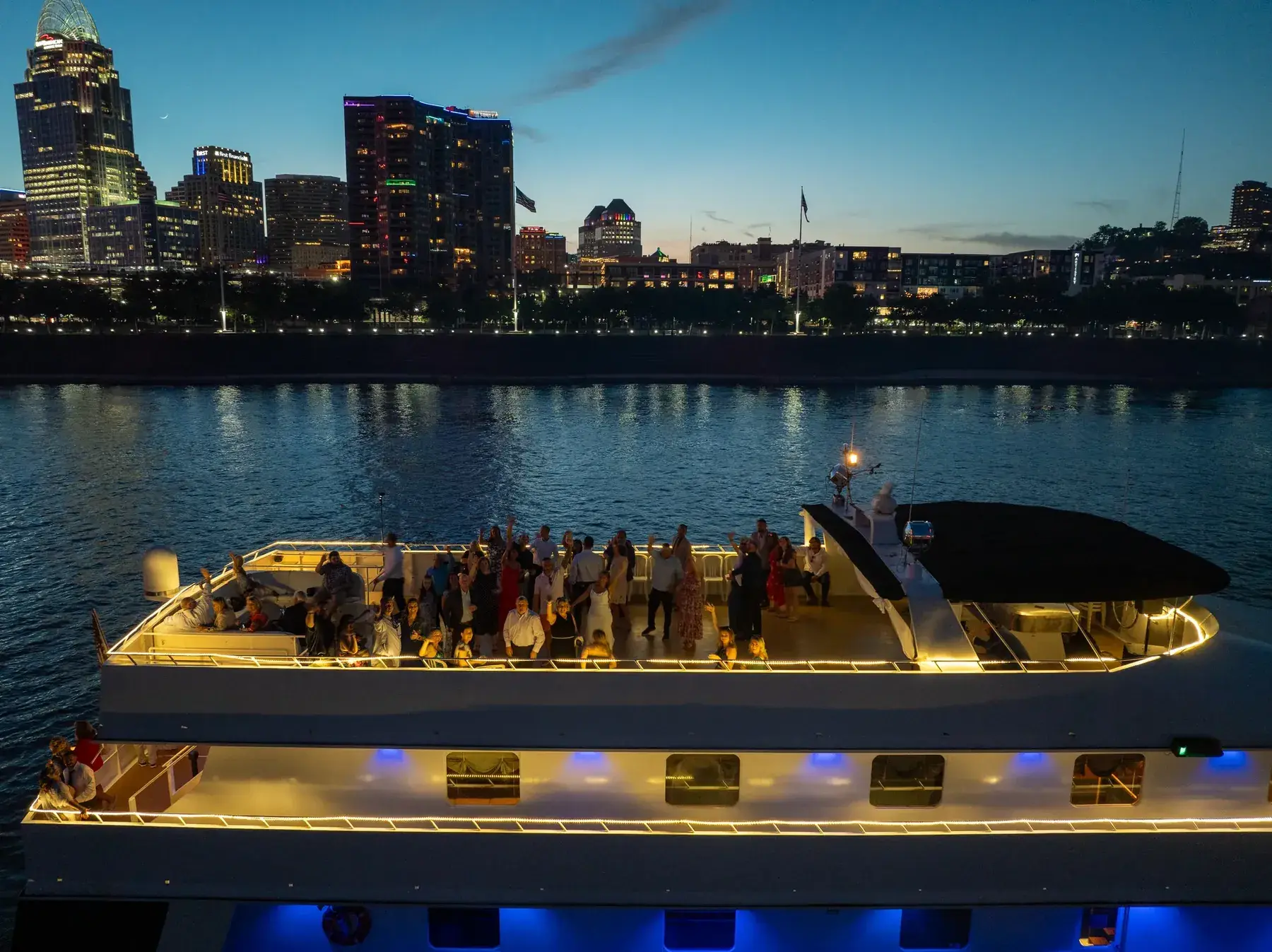 A night reception on the Destiny's deck with the Cincinnati skyline behind