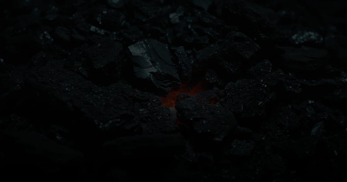 A single ember glowing beneath dark forge coal, illustrating the high-ROI workflows Cincinnati service businesses should automate first